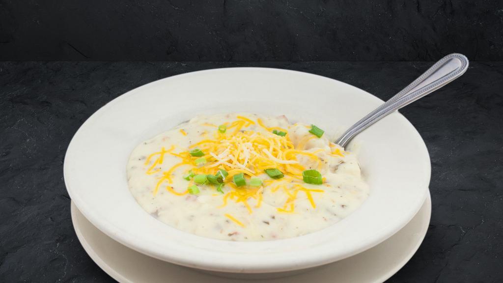 Creamy Potato Soup · We add bacon and top it generously with cheddar cheese and chives.