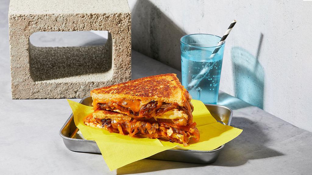 The Bbq Chicken · Melted Cheddar and jack cheese with chicken, barbecue sauce and caramelized onions grilled between two slices of buttered bread.