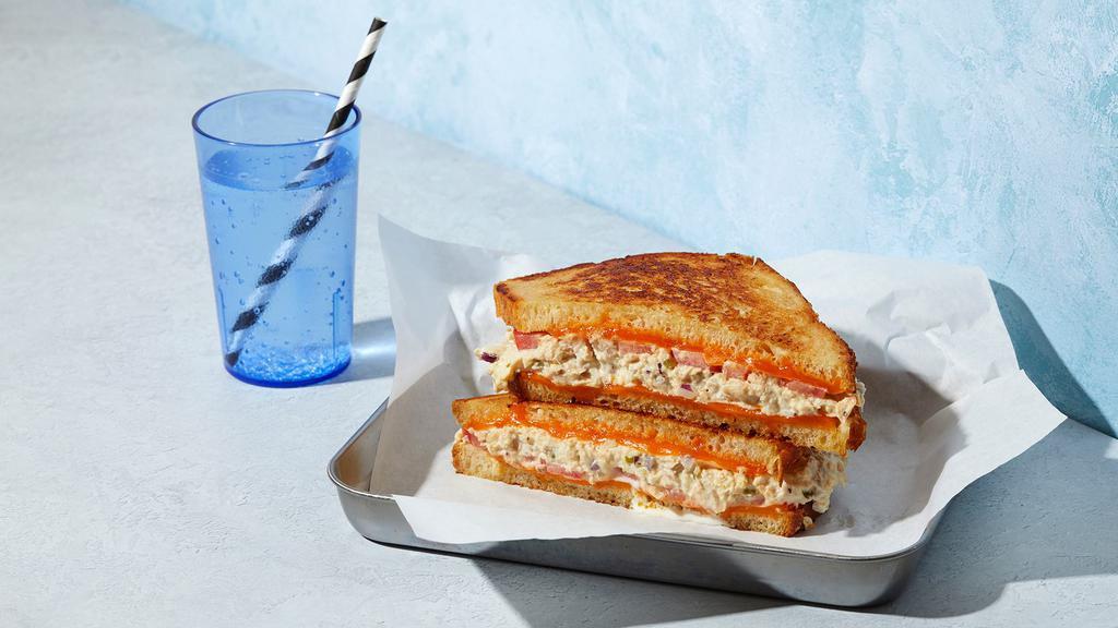 The Tuna Melt · Melted Cheddar cheese with tuna salad and tomato grilled between two slices of buttered bread.