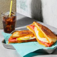 The Breakfast · Melted Cheddar cheese with a fried egg and tomato grilled between two slices of buttered bre...