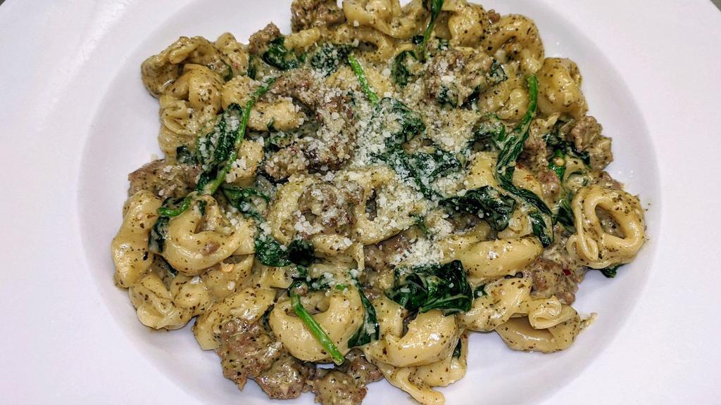 Tortellini  Di Basilico Con Salsiccia · 3 Cheese Tortellini In A Creamy Basil Pesto Sauce With Italian Sausage And Spinach,  Served with garlic bread and house salad.