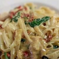 Tuscan Chicken · Sliced chicken breast, sun-dried tomatoes, roasted red peppers and spinach tossed with Fettu...