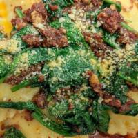 Ravioli Di Spinaci · Ravioli pasta with spinach and Ricotta tossed in a sun-dried tomato and garlic pesto served ...