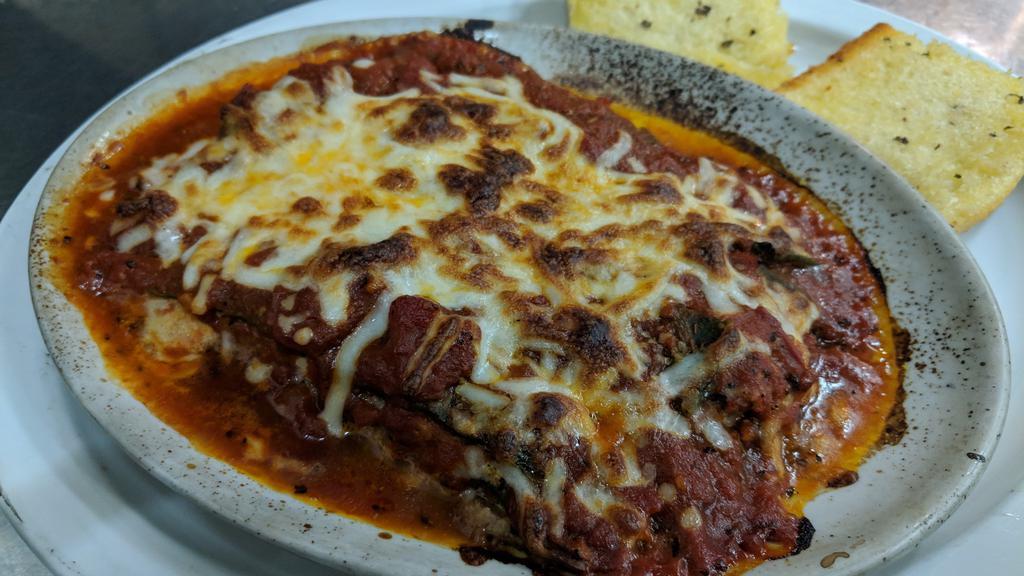 Lasagne Emiliana (Signature Dish) · Northern Italian style lasagna, layered with fresh spinach pasta, shredded beef loin, sausage, Ricotta, Parmesan, Mozzarella and tomato sauce, baked and topped with more Mozzarella.