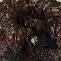 Molten, Chocolate Cake · Moist dark chocolate cake drizzled with dark chocolate and filled with a dark chocolate truf...