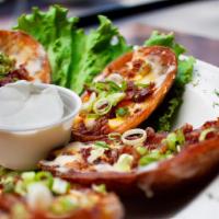 Potato Skins · Potato boats topped with melted cheddar & jack cheeses, bacon and chives. Sour cream on the ...