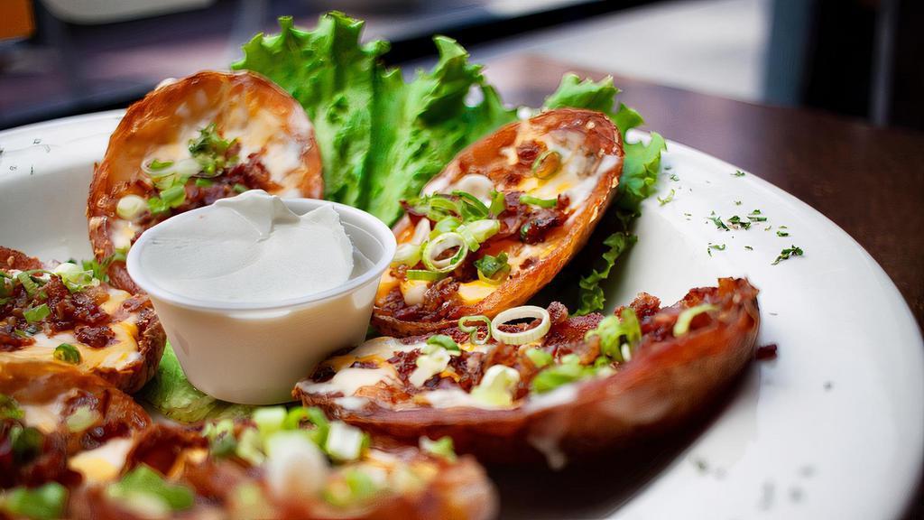 Potato Skins · Potato boats topped with melted cheddar & jack cheeses, bacon and chives. Sour cream on the side.