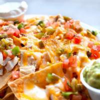 Nachos · Tortilla chips topped with seasoned ground beef, chicken or both, plus melted cheddar & jack...