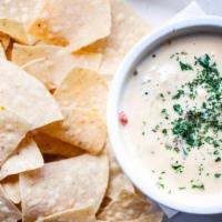 Chips & Queso · Onions, garlic, tomatoes, green chiles & jalapeños in our savory melted cheese dip. Served w...