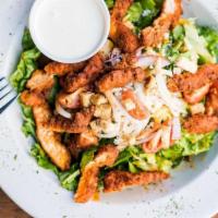 Buffalo Chicken Salad · Leafy greens topped with buffalo chicken strips, red onions, tomatoes and bleu cheese crumbl...