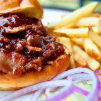 Shiner Bbq Brisket Sandwich · Shiner-marinated beef brisket tossed in BBQ sauce and served on a burger bun. Onions and pic...