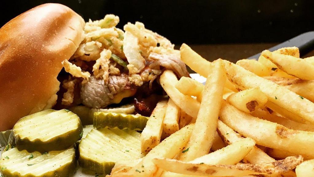 Brisket Burger · Your choice of patty topped with chopped brisket, cheddar cheese and fried jalapeño onion strings with pickles on the side. Served with fries.