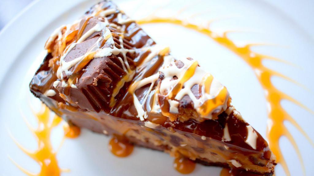 Chocolate Peanut Butter Pie · Peanut butter mousse and milk chocolate on a chocolate cookie crust. Topped with chocolate, caramel, Reese's Peanut Butter Cups and peanut butter drizzle.