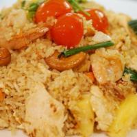 Pineapple Fried Rice · A mixture of pineapple, cashew nuts, raisins, onions, scallions, egg, stir-fried with your c...