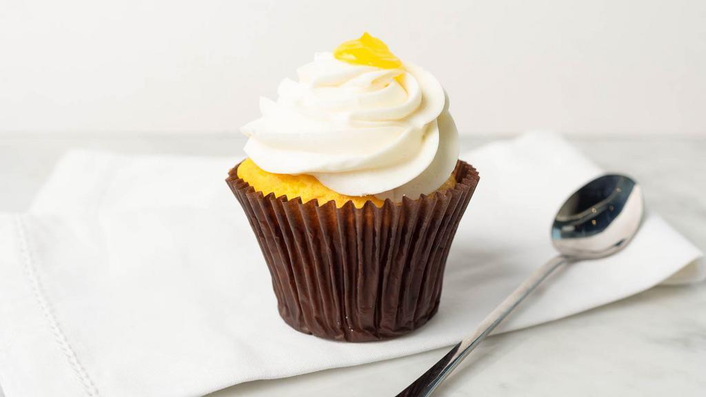 Lemon Drop Cupcake · Lemon cake filled with tangy lemon curd, topped with our signature lemon buttercream icing and a dollop of tangy lemon curd.