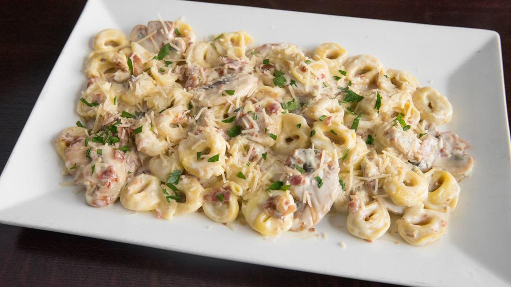 Soprano'S Special Pasta · Cheese filled tortellini, bacon, mushrooms, alfredo sauce, and parmesan. Served with garlic bread.