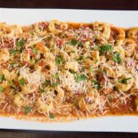 Cheese Tortellini Pasta · Pasta rings filled with cheese and topped with alfredo or marinara sauce. Served with garlic...