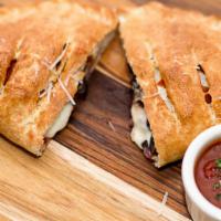 The House Calzone · Pepperoni, sausage, ricotta cheese, onions, and mushrooms.
