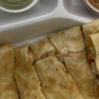 Quesadillas (Beef) · Large grilled tortilla filled with cheddar and mozzarella cheeses, chives, diced tomatoes, a...