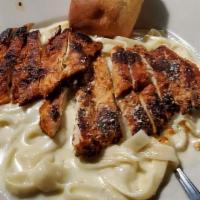 Chicken Alfredo · Lightly breaded and seasoned chicken breast sautéed and served over fettuccine with homemade...