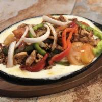 Queso Flameado · Choice of grilled steak, chicken, or shrimp atop melted Monterrey cheese, garnished with gri...