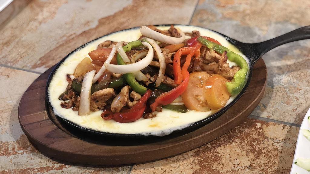 Queso Flameado · Choice of grilled steak, chicken, or shrimp atop melted Monterrey cheese, garnished with grilled tomatoes, onions and bell peppers. Served with warm tortillas.