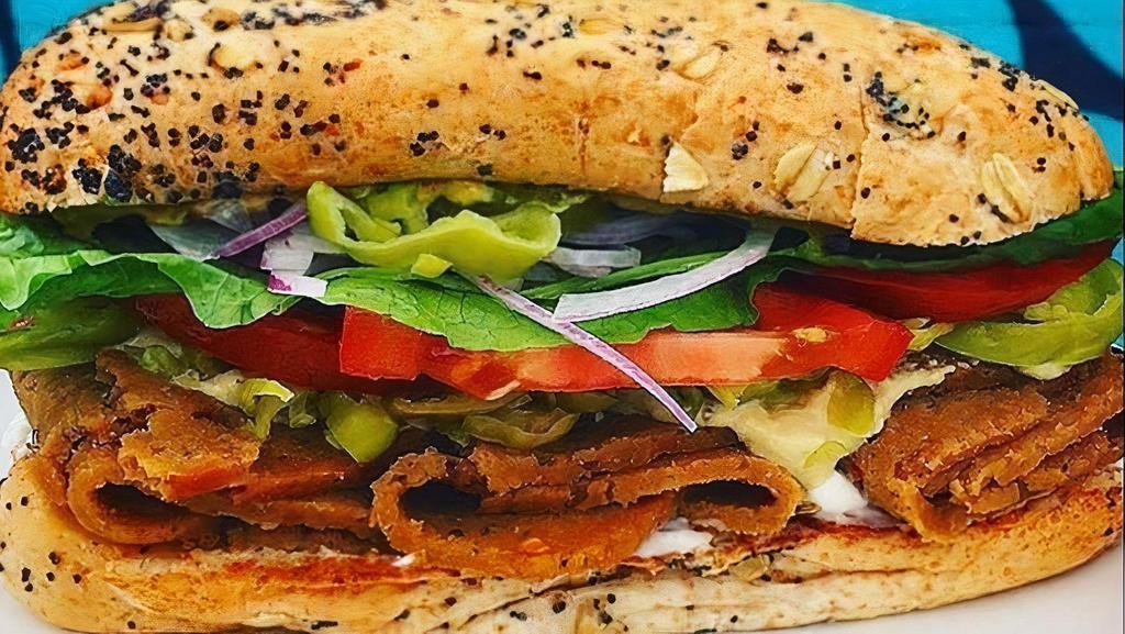 Seitan Sub Supreme · House-made seitan pastrami, mayo, pepperoncini, cashew cheeze, local tomato, lettuce, house-made pickles, red onion & mustard on a hoagie.  Contains nuts, soy & gluten.