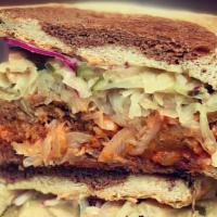 Seitan Pastrami Sandwich · House-made seitan, thousand island, sauerkraut, onions, pickles and melted swiss on local ma...