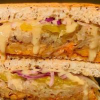 Tempeh Reuben Sandwich · Marinated local tempeh, thousand island, sauerkraut, onions, pickles and melted swiss on loc...