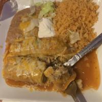 Carnitas Burrito
 · Traditional carnitas or chile verde pork with spanish rice, refried beans, and cheese in a f...