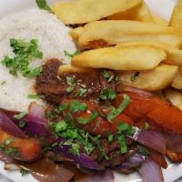 Saltado · Tender steak or chicken wok sautéed in olive oil with onions and tomatoes. Served over fries.