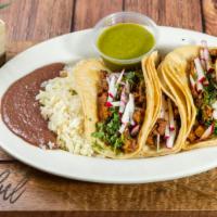 Tacos Al Carbon · Favorite. Tacos charcoal style. Three corn tortillas filled with a choice of protein and ser...