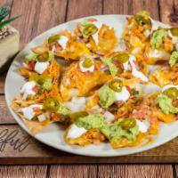 Nachos · Served with refried beans, cheese, guacamole, sour cream and jalapeño.