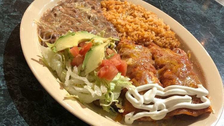 Enchiladas Plate · Pinto Beans, Rice, Two Corn Tortillas, Chicken or Beef, Cheese, Lettuce, Tomatoes, Sour Cream, Avocado Slices.