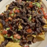 Super Nachos · Tortilla Chips, Pinto or Black Beans, Guacamole, Melted Cheese, Sour Cream with Meat.