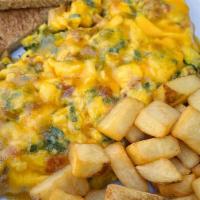Protein Lover’S Scramble · Three eggs scrambled with grilled chicken, bacon, cheddar cheese & spinach, served with toas...