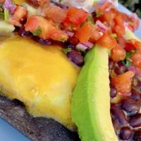 Huevos Rancheros · Two eggs over medium, topped with cheddar cheese, avocado, black beans, salsa & sour cream o...