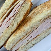 Kids Turkey & Swiss Sandwich · Served on sourdough with mayo, with fresh fruit or french fries