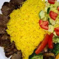 Lamb Kebab · Lamb sirloin served with our special sauce, basmati rice, sautéed veggies, and side salad. (...