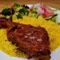 Lamb Shank · Roasted Lamb Shank served with our special sauce, basmati rice, sautéed veggies, and side sa...