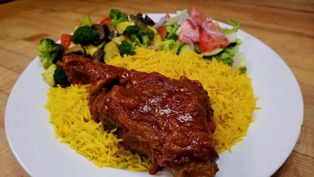 Lamb Shank · Roasted Lamb Shank served with our special sauce, basmati rice, sautéed veggies, and side salad (gluten free)