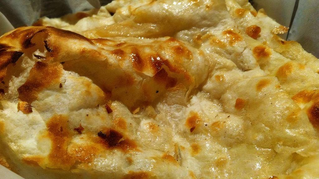 Plain Naan · White flour bread topped with butter.