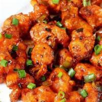 Gobi Manchurian · Gobi refried and sprinkled with onions, chaat masala.
