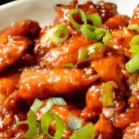 Baby Corn Manchurian · Baby corn refried and sprinkled with onions, chaat masala.