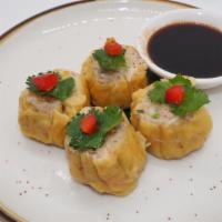 Steamed Thai Dumpling · Wonton skin stuffed with shrimp chicken, crabmeat served with garlic black soy sauce.
