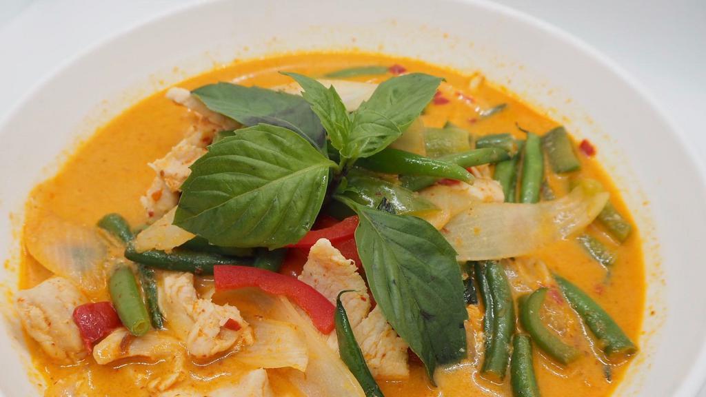 Red Curry · Spicy red curry paste, coconut milk, eggplant, bell peppers, bamboo shoot, string beans and basil.