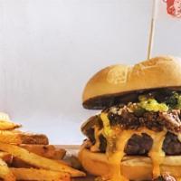 Loaded Queso Burger · beef patty, Trudy's queso, spiced beef, pico, pickled jalapenos, avocado salsa, queso cotija