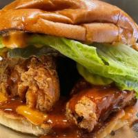 Nashville Hot Chicken Sandwich · Crispy, Fried, chicken tenders smothered in Nashville Hot sauce and topped with lettuce, pic...