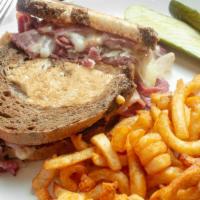 Reuben · Hot corned beef, turkey, or pastrami, swiss cheese, russian dressing and sauerkraut on marbl...