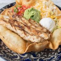 Uncle Rico'S Taco Salad · Flour tortilla bowl filled with Lettuce, Tomatoes, Sour Cream, Rice, Beans, Cheese and your ...